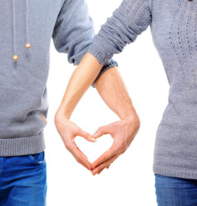 Valentine Couple in love showing Heart with their fingers